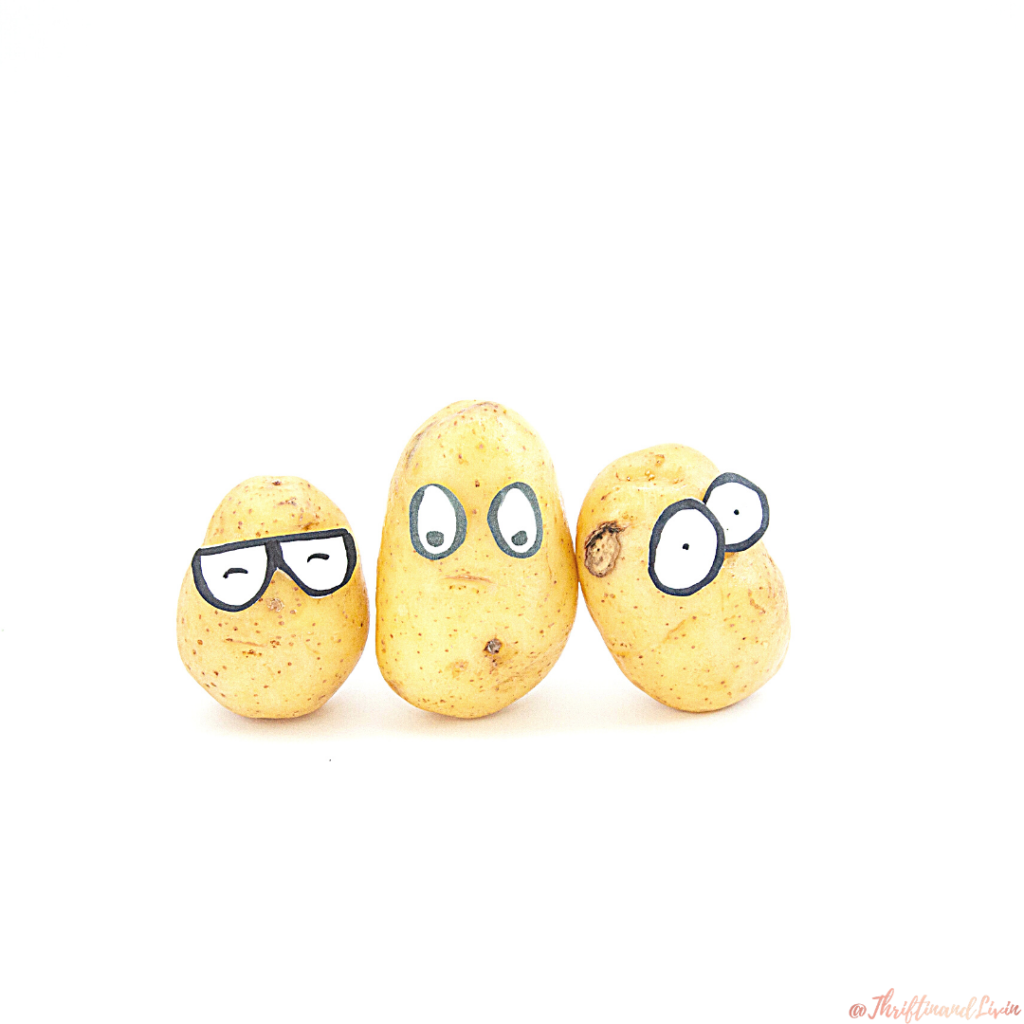 Three potatoes with silly eyes in front of a white background waiting to be used to stretch a meal.