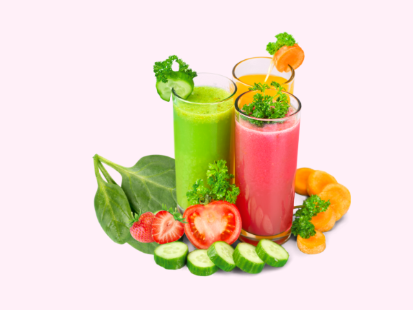 Get kids to eat their vegetables by adding them to smoothies like the three pictured here on this light pink background.