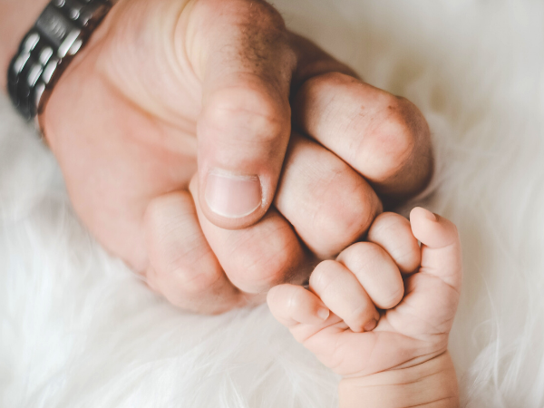 Dad and baby fist bump for this list of frugal Father's Day gift ideas!