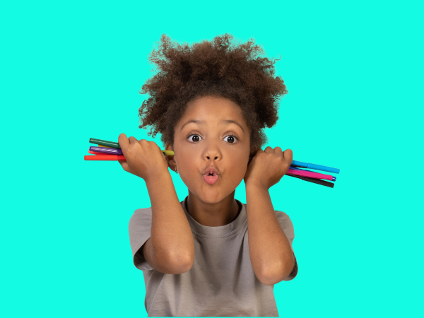 Adorable young girl holding markers up to both ears while making a silly face. You can save money on school supplies by buying budget-friendly basics and letting the kids decorate them with markers and/or stickers.