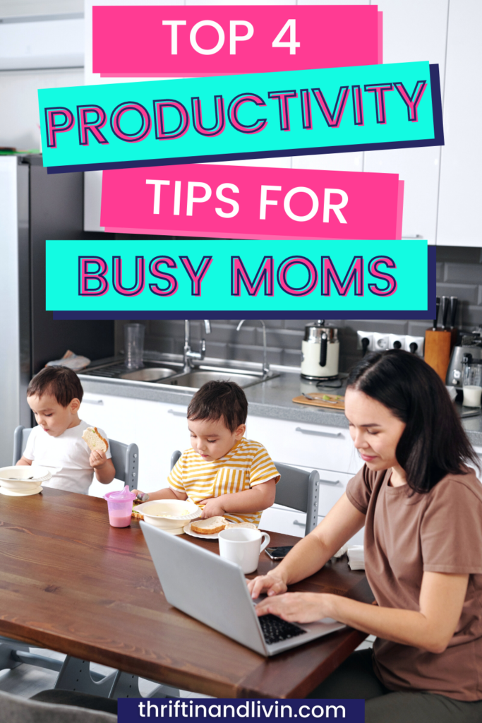 Pinterest Pin image with mom and her two young children at their kitchen table as the bright gray and white background for the image. Mom is working on her laptop while her two young children eat. At the top of the image, there are pink and bright teal banners with pink and white text that says, "Top 4 Productivity Tips for Busy Moms"